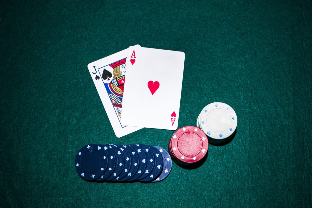 jack-spade-heart-ace-card-with-casino-chips-stack-green-poker-table (2) (1)